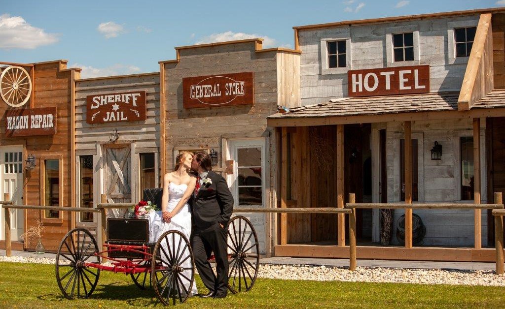 couple on wagon front of buildings